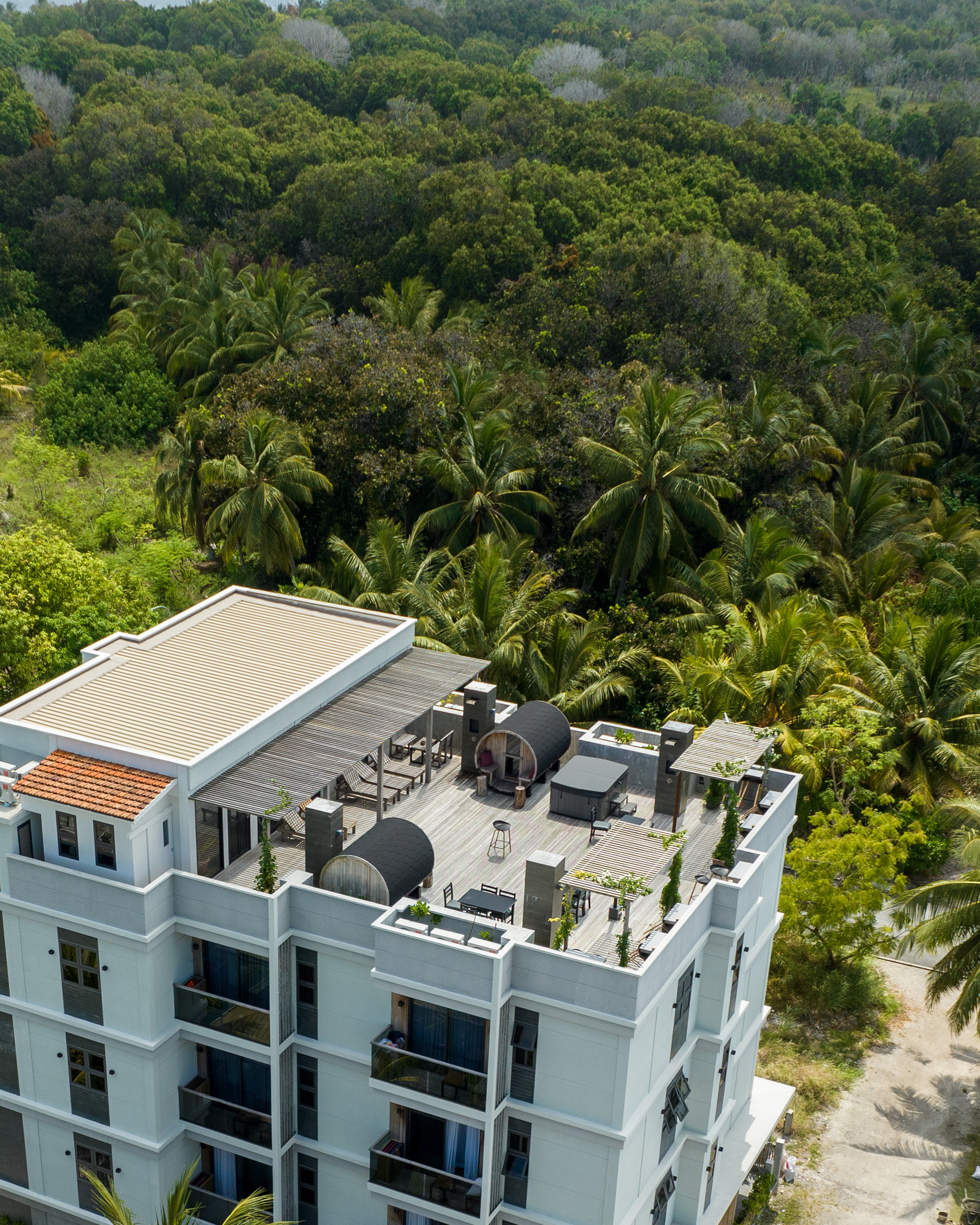 Aerial view of Ataraxis Grand and Spa among the greenery of Fuvahmulah