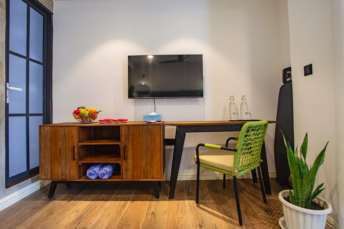 Room amenities and work area at Beach Hotel Dhigurah